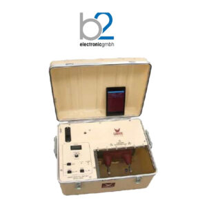 Portable electrical testing equipment with a digital display and red connection terminals housed in an open tan case, branded with the b2 electronicgmbh logo.